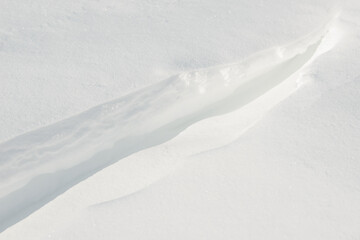 Fresh clean white snow background texture. Winter background with snowflakes and snow mounds. Snow lumps. Seasonal landscape details.