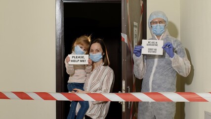 sick family of mother and daughter opening door with warning tapes in corridor entrance for doctor i