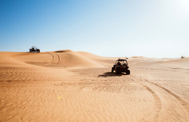  Two riding quad buggy bikes at Al awir arabic desert sand hills, extreme sports transport, fun driving