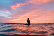Young Surfer Boy, Surfing At Sunset On A Portuguese Beach. Copy Space