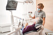 © Yakobchuk Olena - Dentist and patient looking at the results of whitening