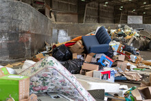 Piles Of Refuse And Garbage In A Solid Waste Station Or Dump Including Mattresses, Chairs And Cardboard.