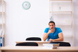 © Elnur - Exhausted male student preparing for the exams in the classroom