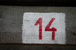 Closeup shot of number 14 on a wooden surface