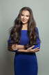© millaf (Nemchinova) - Cute young brunette woman in blue dress standing on white background