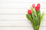 Fototapeta Tulipany - Bunch of spring tulips over white wooden background
