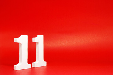 Eleven ( 11 ) white number wooden on Red Background with Copy Space - New promotion 11% Percentage  Business finance Concept 