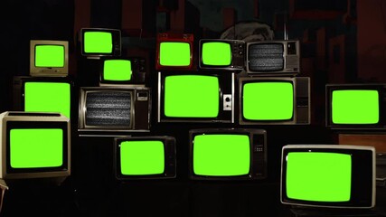 Wall Mural - stack of retro vintage tv turning on green screens. you can replace green screen with the footage or