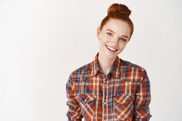 Wall Mural - Headshot Portrait of happy ginger girl with freckles smiling looking at camera. White background