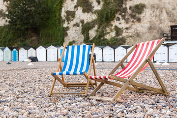 Two Empty Deckchairs on a Beach with No Holidaymakers Due To Worldwide Pandemic Lockdown