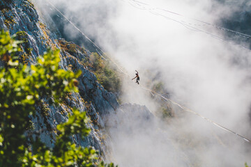 Wall Mural - Highliner goes on a sling above the clouds.