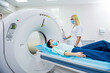 © romaset - Radiologist with a female patient in the room of computed tomography