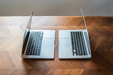 Two laptops facing eachother on table