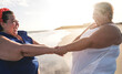 © DisobeyArt - Happy curvy women dancing on the beach during summer vacation - Focus on right woman face