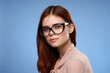 © SHOTPRIME STUDIO - charming woman wearing glasses elegant style luxury cropped view blue background