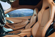 © UnPinky - Modern supercar interior with leather panel, sport seats, multimedia and digital dashboard