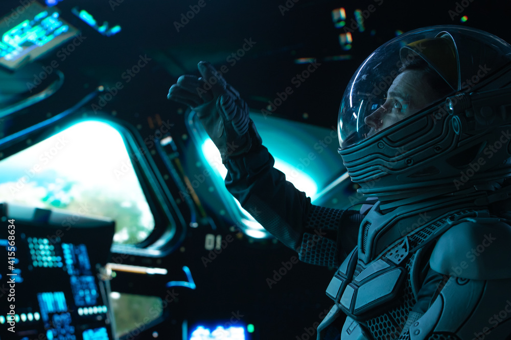 Portrait of Caucasian male astronaut inside spaceship cockpit. Sci-fi space exploration concept - obrazy, fototapety, plakaty 