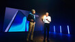 © Framestock - Male speakers discussing new smartphone on stage
