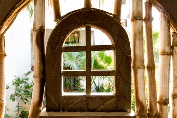 Wall Mural - Old wooden doors at the beautiful tropical garden