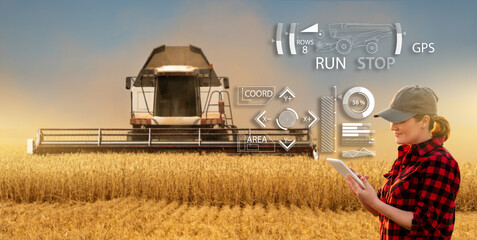 Autocollant - Remote control of an autonomous combine in the field.  Farmer  with a digital tablet in the agricultural field.