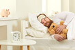 © Studio Romantic - Happy grown-up man sleeping in good comfortable bed with cute teddy bear. Funny guy lying on white pillows and dreaming sweet dreams in deep sleep at 10 am in Covid-19 lockdown or on weekend morning