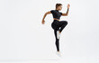 © Liubov Levytska - Dynamic movement of young and healthy sports woman doing jump exercising in sportswear. Fitness female in sport costume raising leg, running on white background