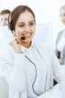 © Iryna - Call center. Group of diverse operators at work. Beautiful woman in headset communicating with customers of telemarketing service. Business concept