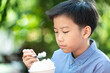 © TinPong - Young Asian boy eat white rice from a bowl