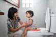© Odua Images - woman and baby poop with toilet background in the bathroom