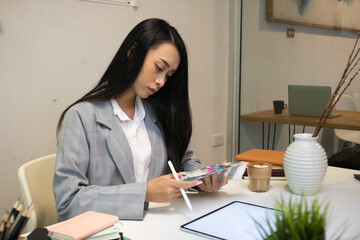 cropped shot of two ui developers meeting on their project with paperwork and tablet on meeting tabl