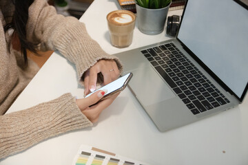 cropped shot of two ui developers meeting on their project with paperwork and tablet on meeting tabl
