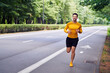© baranq - Male jogger running in park