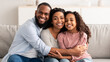© Prostock-studio - Portrait of a happy black family smiling at home