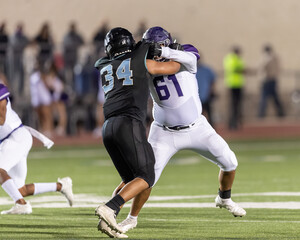 Boy athlete playing in a competitive football game