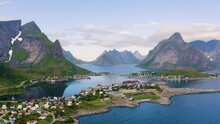 Flying above Reine fishing village with mountains and fjords on Lofoten islands