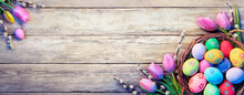 Easter Decoration - Painted Eggs In Basket With Tulips On Natural Wooden Plank