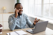 © Prostock-studio - African American Businessman Talking On Mobile Phone Sitting At Workplace