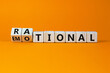 Rational or emotional symbol. Turned wooden cubes and changed the word 'rational' to 'emotional'. Beautiful orange background. Psychological and rational or emotional concept. Copy space.