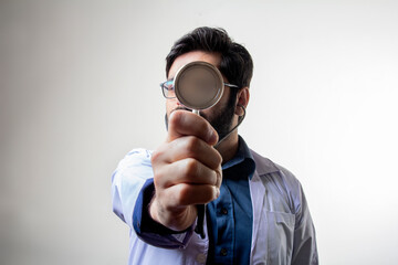 Wall Mural - A doctor holding stethoscope pointing in front covering face