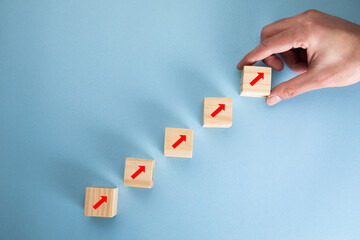 Wall Mural - Wooden cubes to the top with arrows.