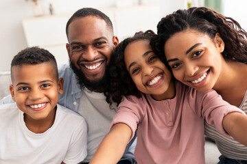 Portrait of african american family taking a selfie together at home