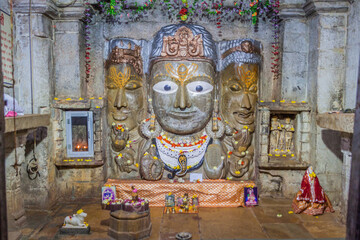 Wall Mural - CHITTORGARH, INDIA - FEBRUARY 15, 2017: Trimurti - three faces of Lord Shiva in Samadhisvar (Samidheshwar) Temple at Chittor Fort in Chittorgarh, Rajasthan state, India