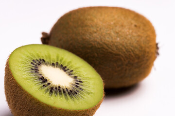 Close-up of two fresh kiwis on white background