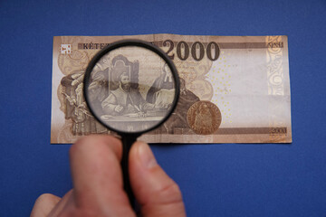 Wall Mural - Hungarian 2000 forint paper money banknote. Examine through the magnifying glass. Bank image and photo.