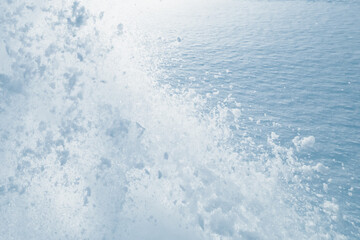 Wall Mural - snow splash in the air, blue snow background