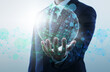 © tadamichi - Business and global network technology. Businessperson holding network structure and wire frame sphere.
