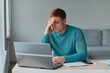 © yavdat - Business man Having Headache While Working Using Laptop Computer. Stressed And Depressed man Touching Head, Feeling Pain While Sitting At Wooden Tabl, Work Failure Concept