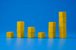 Up and down chart graph made with yellow wooden blocks on blue background. Trends and performance analysis concept