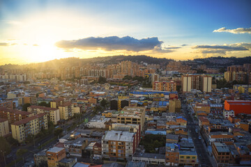Wall Mural - aerial shot of a cityscape with a sunrise background in bogota, colombia