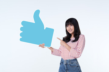 Young happy cheerful asian woman showing thumb up or like sign isolated on white background.